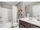 Cozy bathroom featuring a shower/tub combo, wood shelves, and a sink at 4460 Hunters Walk Way, Cumming, GA 30028