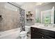 Stylish bathroom features a shower-tub combo, floating shelves, and modern fixtures at 4460 Hunters Walk Way, Cumming, GA 30028