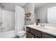 Bathroom with shower over tub and wood shelves at 4460 Hunters Walk Way, Cumming, GA 30028