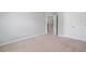 This bedroom features soft carpeting and a doorway leading to the hallway at 4460 Hunters Walk Way, Cumming, GA 30028
