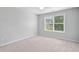 A bright bedroom offers comfortable carpet and natural light from a large window at 4460 Hunters Walk Way, Cumming, GA 30028