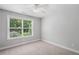 Bedroom with large window, light gray walls, carpet, and white trim at 4460 Hunters Walk Way, Cumming, GA 30028