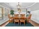 Elegant dining room with a large window and a stylish chandelier at 4460 Hunters Walk Way, Cumming, GA 30028