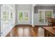 Elegant dining room featuring hardwood floors, wainscoting, and French doors at 4460 Hunters Walk Way, Cumming, GA 30028
