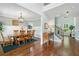 Bright dining room features hardwood floors, a large wooden table set, and decorative wainscoting at 4460 Hunters Walk Way, Cumming, GA 30028