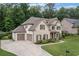 Spacious home featuring a three-car garage and a beautifully landscaped yard at 4460 Hunters Walk Way, Cumming, GA 30028