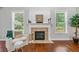 Comfortable seating area with hardwood floors, brick fireplace, mantle and bright natural light at 4460 Hunters Walk Way, Cumming, GA 30028