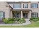 Inviting front entrance featuring a cozy sitting area and decorative landscaping at 4460 Hunters Walk Way, Cumming, GA 30028