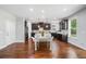 Bright kitchen with dark cabinets, stainless appliances, island, and eat in dining area at 4460 Hunters Walk Way, Cumming, GA 30028