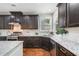 Kitchen with stainless appliances, island with granite countertops, and dark wood cabinets at 4460 Hunters Walk Way, Cumming, GA 30028