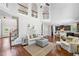 Bright living room with hardwood floors, fireplace, tall windows and an open concept to the kitchen at 4460 Hunters Walk Way, Cumming, GA 30028