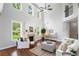 Bright living room with hardwood floors, fireplace, tall windows and comfortable seating at 4460 Hunters Walk Way, Cumming, GA 30028