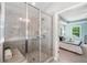 Main bathroom features glass enclosed tiled shower with bench and linen storage at 4460 Hunters Walk Way, Cumming, GA 30028