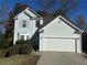 Charming two-story home features a two car garage, light siding, and well-maintained landscaping at 138 Shady View Pl, Lawrenceville, GA 30044