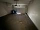 Garage features a cement floor, overhead garage door and two waste receptacles at 138 Shady View Pl, Lawrenceville, GA 30044