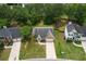 Aerial view of the home showcasing well-manicured lawn, driveway, mature trees, and traditional architecture at 3025 Andora Sw Dr, Marietta, GA 30064