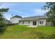 Large backyard with green lawn, mature trees, patio, and privacy fence at 3025 Andora Sw Dr, Marietta, GA 30064