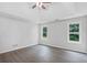 Spacious bedroom features hardwood floors, a tray ceiling, and two windows overlooking the backyard at 3025 Andora Sw Dr, Marietta, GA 30064