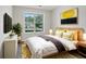 A bedroom with a large window, gray wood look floors and stylish decor at 3025 Andora Sw Dr, Marietta, GA 30064