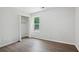 A light-filled bedroom features wood look flooring and a closet at 3025 Andora Sw Dr, Marietta, GA 30064