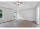 Spacious bedroom features hardwood floors, a tray ceiling, and two windows overlooking the backyard at 3025 Andora Sw Dr, Marietta, GA 30064