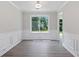Dining area with sleek modern flooring, wainscoting, and large window at 3025 Andora Sw Dr, Marietta, GA 30064