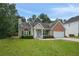Charming single-story home featuring a brick facade, attached garage, and well-maintained front lawn at 3025 Andora Sw Dr, Marietta, GA 30064
