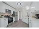 Bright kitchen features white cabinets, stainless steel appliances, and hardwood floors at 3025 Andora Sw Dr, Marietta, GA 30064