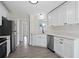 Bright kitchen features white cabinets, stainless steel appliances, and hardwood floors at 3025 Andora Sw Dr, Marietta, GA 30064