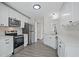 Bright kitchen features white cabinets, stainless steel appliances, and hardwood floors at 3025 Andora Sw Dr, Marietta, GA 30064
