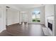 Living room with a fireplace, large arch window, and ample natural light at 3025 Andora Sw Dr, Marietta, GA 30064