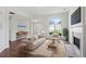 Decorated living room with comfortable seating, a fireplace, and a large window at 3025 Andora Sw Dr, Marietta, GA 30064