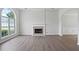 Bright living room featuring a fireplace, large window, and sleek flooring at 3025 Andora Sw Dr, Marietta, GA 30064