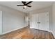 Empty bedroom features hardwood floors, neutral paint, double door closet, and ceiling fan at 3609 Centerville Rosebud Rd, Snellville, GA 30039