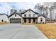 Beautiful modern farmhouse with stylish dark trim, covered porch, and a spacious driveway at 3609 Centerville Rosebud Rd, Snellville, GA 30039