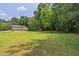 Large backyard with sprawling lawn and wooded area at 4655 Barnes Ct, Loganville, GA 30052