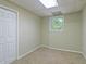 Finished basement area featuring neutral paint and carpet and a window for natural light at 4655 Barnes Ct, Loganville, GA 30052