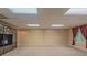 Spacious basement with carpeted floors and large display cabinets at 4655 Barnes Ct, Loganville, GA 30052