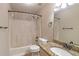 Cozy bathroom with shower-tub combination, decorative granite sink, and bronze fixtures at 4655 Barnes Ct, Loganville, GA 30052
