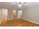 Bedroom with hardwood floors and a view to an ensuite bathroom and hallway at 4655 Barnes Ct, Loganville, GA 30052
