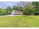 View of a home with an attached two car garage and storage shed out back at 4655 Barnes Ct, Loganville, GA 30052