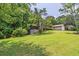 A view of the exterior with a screened in porch and a grassy lawn at 4655 Barnes Ct, Loganville, GA 30052