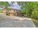 Exterior of a home with a long driveway, wooden deck, and lush trees at 4655 Barnes Ct, Loganville, GA 30052