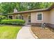 Charming home featuring a manicured lawn, walkway to the front door, and mature trees in a tranquil setting at 4655 Barnes Ct, Loganville, GA 30052