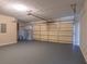 Garage area featuring sealed concrete floors, an automatic garage door, and storage shelves at 4655 Barnes Ct, Loganville, GA 30052