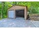 View of two car garage with one door open and a lawnmower inside at 4655 Barnes Ct, Loganville, GA 30052