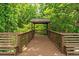 Wooden gazebo located on an outdoor deck surrounded by trees at 4655 Barnes Ct, Loganville, GA 30052