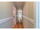 Bright hallway with hardwood floors and white trim at 4655 Barnes Ct, Loganville, GA 30052