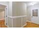 Hallway with hardwood floors, white-painted door frames and chair rail molding at 4655 Barnes Ct, Loganville, GA 30052