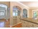 Open concept kitchen with granite countertops and wine rack. Doorways lead to front entrance and living room at 4655 Barnes Ct, Loganville, GA 30052
